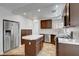 Kitchen featuring stainless steel appliances, an island with tile countertops, and wood cabinets at 8236 Bermuda Beach Dr, Las Vegas, NV 89128