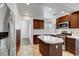 Kitchen with stainless steel appliances, wood cabinets, and an island with a white countertop at 8236 Bermuda Beach Dr, Las Vegas, NV 89128