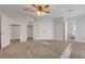 Large bedroom featuring neutral carpet, a ceiling fan, and multiple closets at 8236 Bermuda Beach Dr, Las Vegas, NV 89128