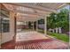 Beautiful patio with a covered pergola, a brick floor and lush green landscaping in the backyard at 8236 Bermuda Beach Dr, Las Vegas, NV 89128