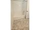 Bright bathroom with white tub and shower featuring tiled walls at 8928 Hand Painted Ct, Las Vegas, NV 89149