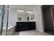 Modern bathroom featuring dual sink vanity, large mirror, and separate tub with shower at 8928 Hand Painted Ct, Las Vegas, NV 89149