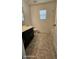 Neutral bathroom with dark vanity, white toilet and bathtub with natural light coming through the window at 8928 Hand Painted Ct, Las Vegas, NV 89149