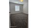 Carpeted bedroom with neutral walls and a large window at 8928 Hand Painted Ct, Las Vegas, NV 89149