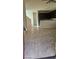 Open entryway with neutral tile flooring leading into the kitchen area with dark cabinets at 8928 Hand Painted Ct, Las Vegas, NV 89149