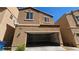 Two-story home featuring stucco exterior and open garage at 8928 Hand Painted Ct, Las Vegas, NV 89149