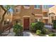 Inviting two-story townhome featuring a well-maintained facade and a landscaped front yard at 8928 Hand Painted Ct, Las Vegas, NV 89149