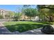 Well-maintained green space in a residential area, enhancing the community's appeal with lush greenery and shade trees at 8928 Hand Painted Ct, Las Vegas, NV 89149