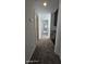Hallway with carpet and dark cabinets at 8928 Hand Painted Ct, Las Vegas, NV 89149