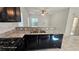Granite countertop bar overlooking a sink, range, and dishwasher in a modern kitchen design at 8928 Hand Painted Ct, Las Vegas, NV 89149