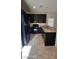 Well-equipped kitchen with dark cabinetry, stainless steel appliances, and a granite countertop bar at 8928 Hand Painted Ct, Las Vegas, NV 89149