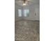 Bright living area featuring tile flooring, natural light, and a ceiling fan at 8928 Hand Painted Ct, Las Vegas, NV 89149