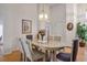 Elegant dining room with a chandelier, artwork, and ample natural light at 8929 Marble Dr, Las Vegas, NV 89134