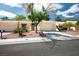 Single-story home featuring desert landscaping, a two-car garage and mature shade tree at 8929 Marble Dr, Las Vegas, NV 89134