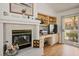 Cozy living room with a fireplace, built-in shelving, and a sliding glass door to the patio at 8929 Marble Dr, Las Vegas, NV 89134