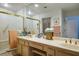Bright bathroom with dual sinks, a vanity, and a walk-in shower at 8929 Marble Dr, Las Vegas, NV 89134