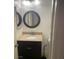 Cozy powder room featuring granite counters, a round mirror, and a dark vanity at 9232 Marlia St, Las Vegas, NV 89123