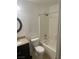 Bright bathroom with a shower-tub combo, granite counters, and tile flooring at 9232 Marlia St, Las Vegas, NV 89123