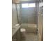 Bright bathroom featuring tile surround, shower over tub, and updated fixtures at 9232 Marlia St, Las Vegas, NV 89123