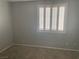 Cozy bedroom featuring neutral paint, carpet flooring, and plantation shutters at 9232 Marlia St, Las Vegas, NV 89123