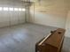 A spacious garage with painted floors, automatic door, and ample storage space at 9232 Marlia St, Las Vegas, NV 89123