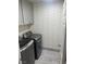 Modern laundry room with gray cabinets and stylish herringbone accent wall at 9232 Marlia St, Las Vegas, NV 89123