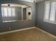 Open-concept living room featuring tile floors, plantation shutters, and neutral paint at 9232 Marlia St, Las Vegas, NV 89123