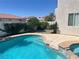 A refreshing pool and spa with lush foliage offers a private backyard retreat at 9232 Marlia St, Las Vegas, NV 89123