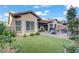Well-maintained backyard with artificial grass, an inviting patio, and lush landscaping at 961 Cutter St, Henderson, NV 89011