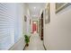 Bright hallway featuring tiled floors, decorative doors, neutral paint, and natural light from a window at 961 Cutter St, Henderson, NV 89011