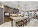 Open kitchen with granite countertops, stainless appliances, and dark wood cabinets at 961 Cutter St, Henderson, NV 89011