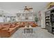 Open living room with large leather sofa, tile floors, ceiling fan, and tasteful decorations at 961 Cutter St, Henderson, NV 89011