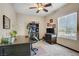 Functional office with a ceiling fan, carpet floors, window, and ample desk space at 961 Cutter St, Henderson, NV 89011