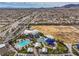 Overhead view of the community featuring a pool, splashpad, and sports field surrounded by homes and desert landscape at 9655 Shadow Cliff Ave, Las Vegas, NV 89166