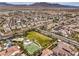 Community aerial view of a basketball court, picnic pavilion, and green space amidst tile roofed homes and desert landscape at 9655 Shadow Cliff Ave, Las Vegas, NV 89166