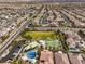 Aerial view of a community with a basketball court, splash pad, and green space amongst tile roofed homes at 9655 Shadow Cliff Ave, Las Vegas, NV 89166