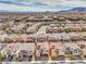 Expansive aerial view of a neighborhood featuring neatly arranged houses and scenic mountain backdrop at 9655 Shadow Cliff Ave, Las Vegas, NV 89166