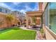 Cozy covered patio with an outdoor seating area and manicured lawn at 9655 Shadow Cliff Ave, Las Vegas, NV 89166