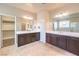 Bathroom with double sink vanity, large mirrors, and a walk-in closet on the left at 9655 Shadow Cliff Ave, Las Vegas, NV 89166
