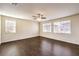 Large bedroom with dark wood floors, ceiling fan, and multiple windows at 9655 Shadow Cliff Ave, Las Vegas, NV 89166