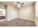 Bright bedroom with carpet, ceiling fan, and en-suite bathroom entrance at 9655 Shadow Cliff Ave, Las Vegas, NV 89166