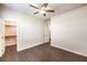 Neutral bedroom with a ceiling fan, wood-look floors, and a walk-in closet at 9655 Shadow Cliff Ave, Las Vegas, NV 89166