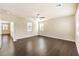 Bedroom with dark floors, ceiling fan, and a hallway leading to other rooms at 9655 Shadow Cliff Ave, Las Vegas, NV 89166