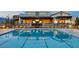 A community pool is enclosed by a black fence near an outdoor dining space for relaxation at 9655 Shadow Cliff Ave, Las Vegas, NV 89166