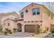 Two-story home features desert landscaping, a two-car garage, and covered entry at 9655 Shadow Cliff Ave, Las Vegas, NV 89166