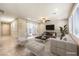 Bright, open-plan living room with a large window, ceiling fan, and tile flooring at 9655 Shadow Cliff Ave, Las Vegas, NV 89166