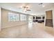 Bright living room features tile floors, ceiling fan, and access to a modern kitchen at 9655 Shadow Cliff Ave, Las Vegas, NV 89166