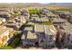 An aerial perspective of a neighborhood showcasing houses, desert landscaping, and surrounding desert at 9986 Sand Key St, Las Vegas, NV 89178