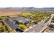 Suburban aerial showcasing community buildings, a golf field, and nearby mountain views at 9986 Sand Key St, Las Vegas, NV 89178