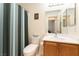 Bathroom with vanity, mirror, and blue striped shower curtain at 9986 Sand Key St, Las Vegas, NV 89178